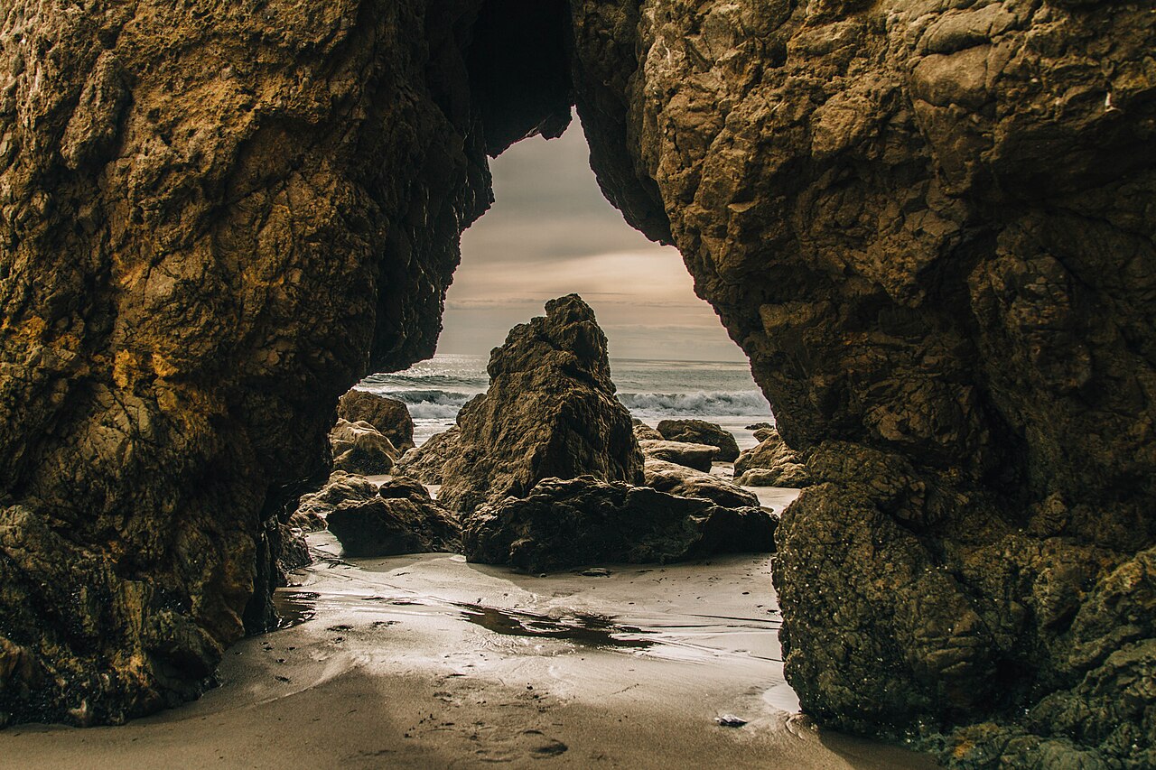 Pacific waves framed by rock formations at El Matador State Beach in Malibu